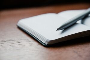 handwritten debt payoff tracker on paper