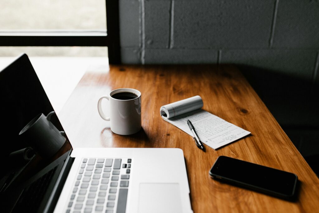 laptop open on home desk used for budgeting