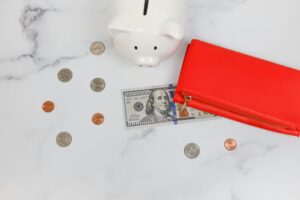 coins and cash on wooden desk