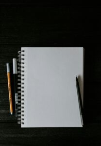 open notebook with budget plan written in pen on desk